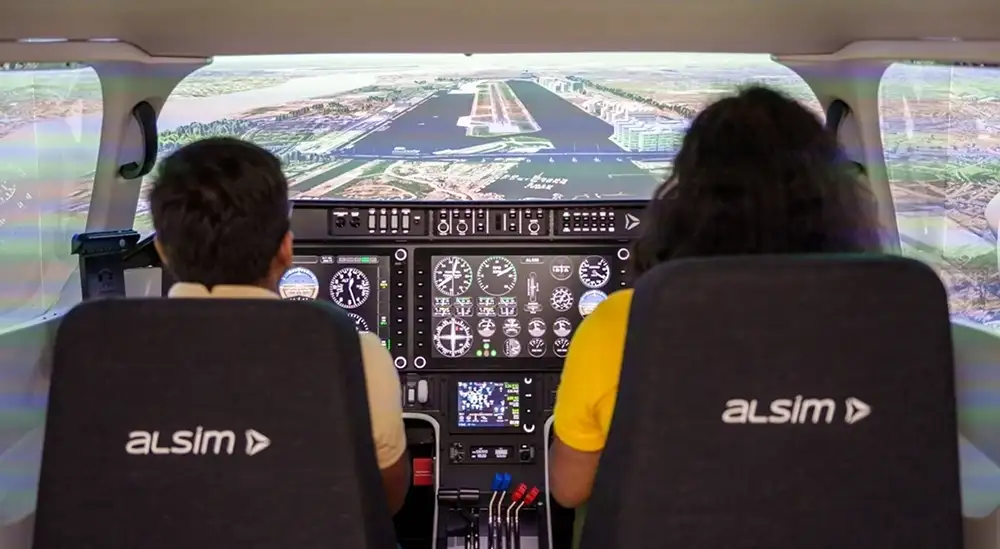 Two students using a flight simulator side by side