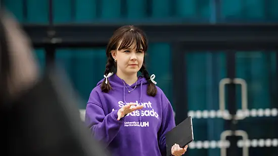 Student talking to people 