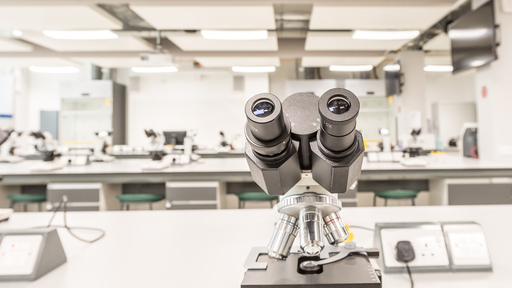 Students wearing lab coats in a lecture